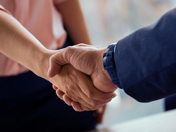 two people shaking hands. 