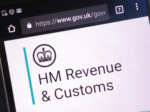 a phone open on the website for GOV.UK the screen shows the 'HM Revenue & Customs' logo. 