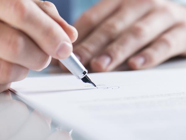 a person signing a document 