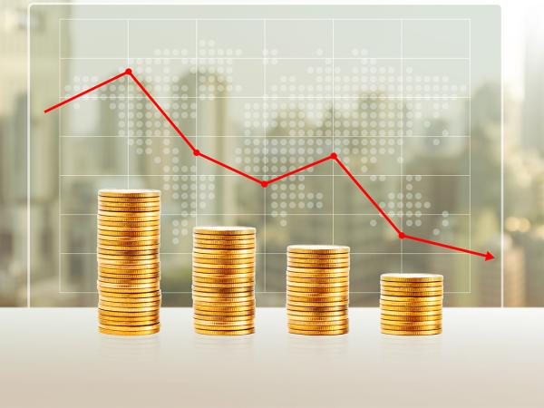 4 piles of coins getting smaller from left to right, a translucent graph sits above showing the decrease with a red line.