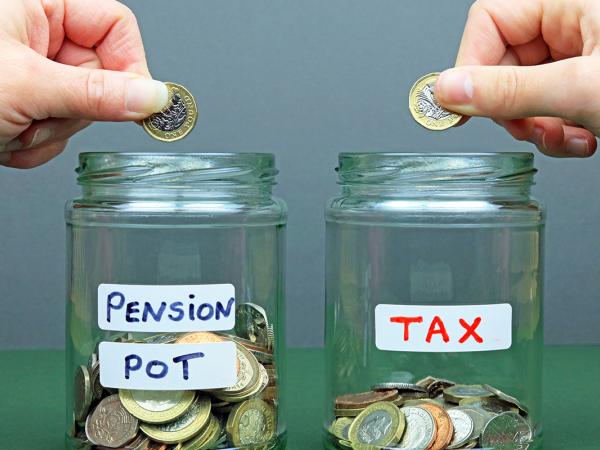 Two glass jars with stickers on them, one says 'PENSION POT' and the other says 'TAX'. A person is putting money into both jars