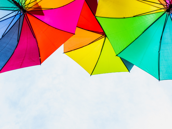 Colourful umbrellas against a blue sky.