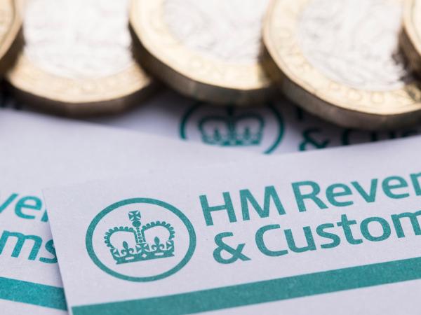 Letters from HMRC showing the HMRC logo with pound coins scattered across the top of these letters. 