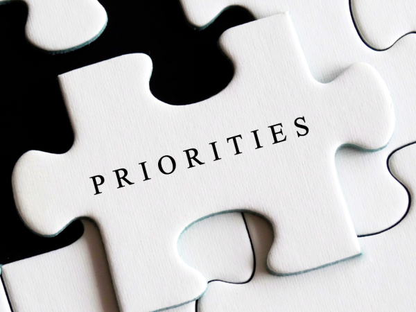 a white jigsaw, the one missing piece has the word 'PRIORITIES' on it in black text.
