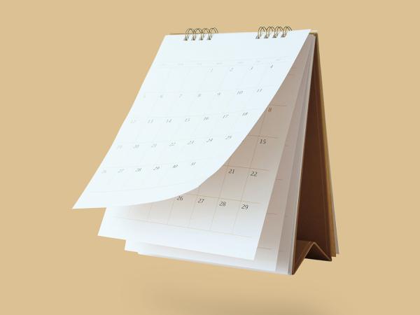 Wall calendar against a natural coloured background. 