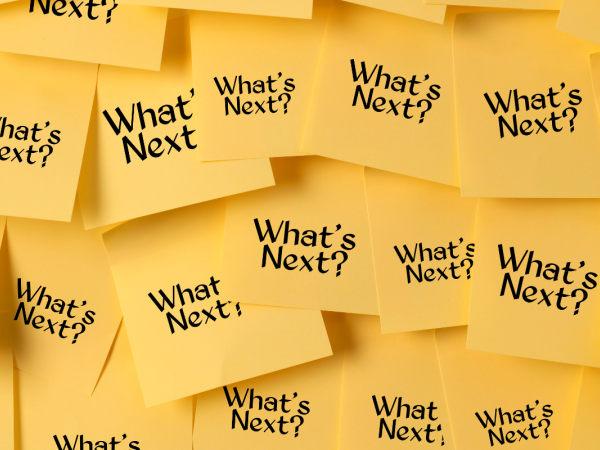 a bunch of post-it notes all with the same words written on them saying 'WHAT'S NEXT?'