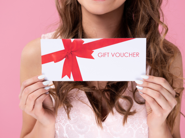 A person holding a voucher in their hands. 