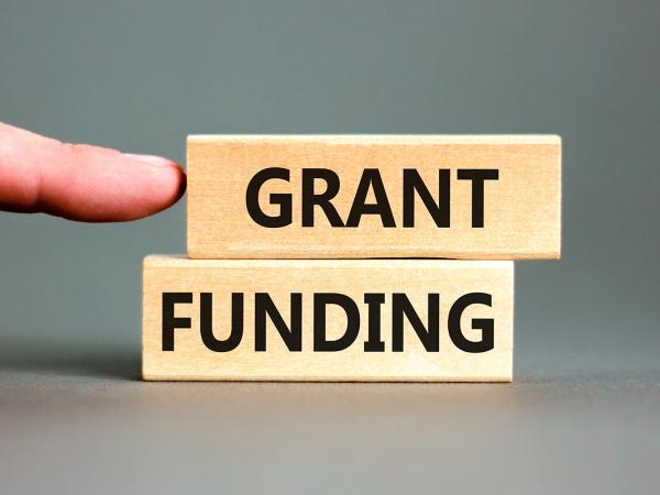 2 blocks of wood each with a word printed on it, together they read 'GRANT FUNDING'.