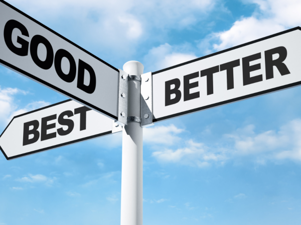 a white street sign with 3 words written on them 'GOOD', 'BETTER', 'BEST'.