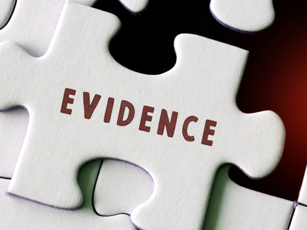 a white jigsaw missing one piece, the missing piece has the word 'EVIDENCE' on it.