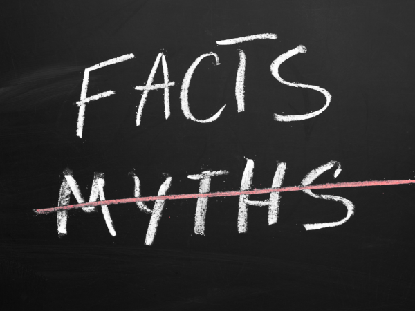 Two words written in white chalk on a chalkboard 'FACTS' and 'MYTHS' the word 'MYTHS' has been crossed out by coloured chalk