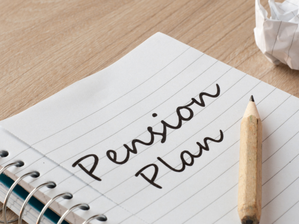 Pad of paper with the words 'PENSION PLAN' written on the page.