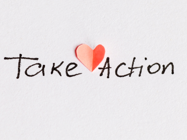 The words 'TAKE ACTION' handwritten in black ink with a red heart.