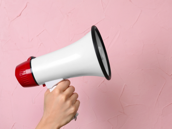 a megaphone against a pink background