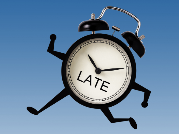 A clock with arms and legs running, on the clock face the word 'LATE' can be seen. 