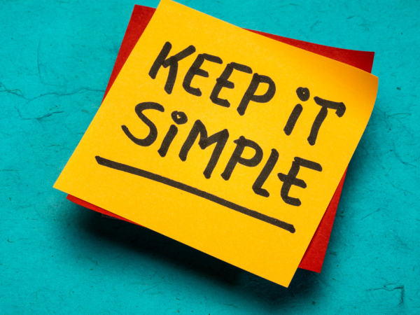 a post it note with the words 'KEEP IT SIMPLE' written in black pen.