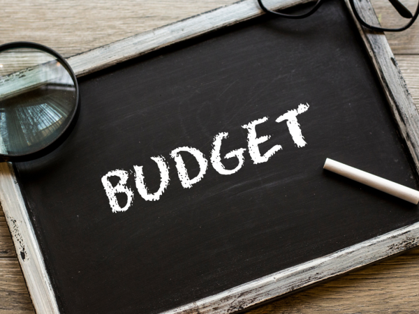 A chalkboard with the word 'BUDGET' written on it in white chalk