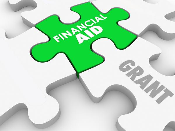 Illustration of jigsaw pieces displaying the words financial aid and grants