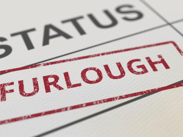 The word furlough stamped on a piece of paper