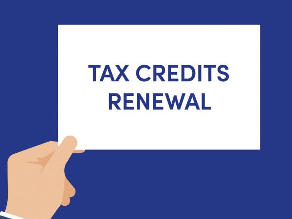 Illustration of a hand holding a sign saying tax credits renewal