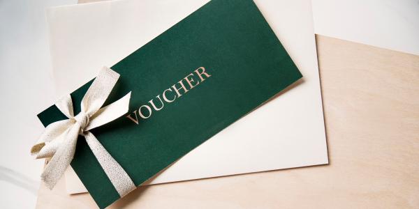 An envelope with the word 'VOUCHER' on the front in white text. 