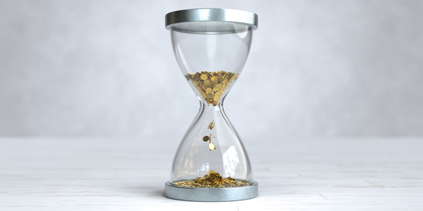 An hourglass but instead of being filled with sand it is filled with golden coins. 