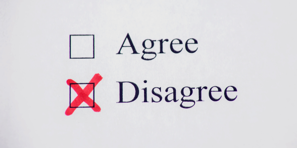 Typed words in black ink on paper 'AGREE', 'DISAGREE' next to each word is a check box. The box against the word 'DISAGREE' is checked with a red cross.