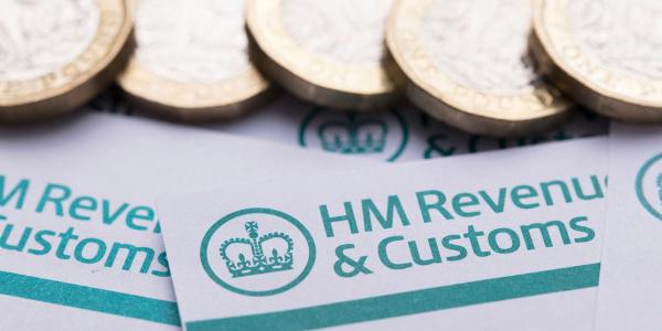 Letters from HMRC showing the HMRC logo with pound coins scattered across the top of these letters. 