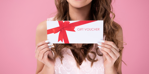 A person holding a voucher in their hands. 