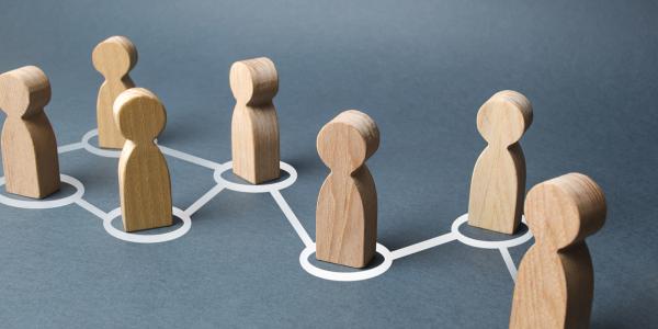 7 wooden figures each has a white circle around it, all circles are interlinked with a white line from one to another. 