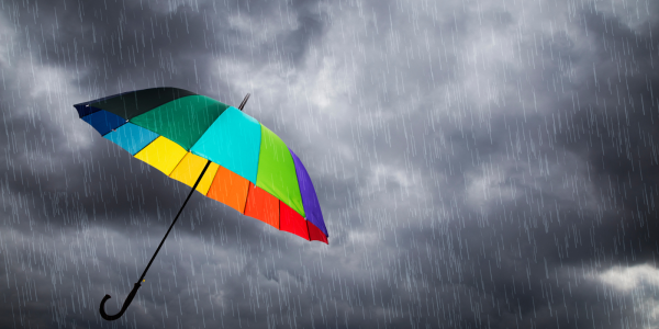 a grey sky with a colourful umbrella