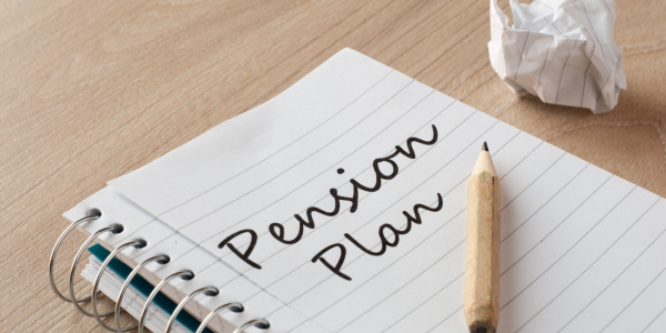 Pad of paper with the words 'PENSION PLAN' written on the page.
