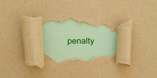 A piece of brown paper with a tear in the center, through the tear a green sheet of paper with the word 'PENALTY' can be seen.
