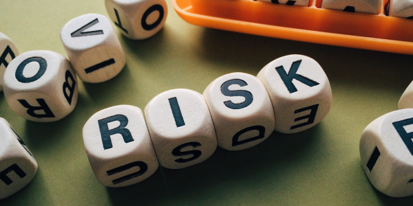 wooden cubes each containing a letter - together spells out the word 'RISK' 