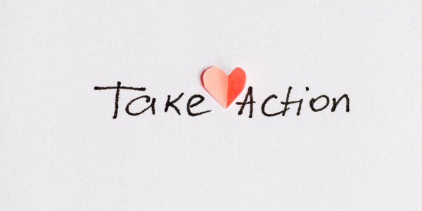 The words 'TAKE ACTION' handwritten in black ink with a red heart.