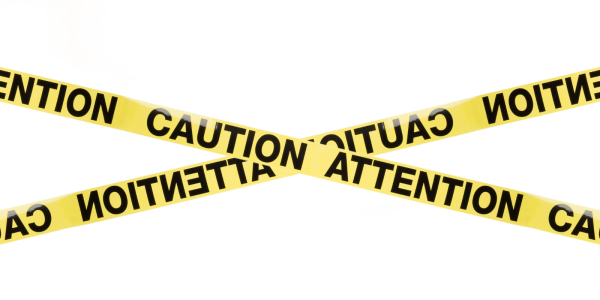 Yellow tape with the words 'CAUTION' and 'ATTENTION' in black capitals 