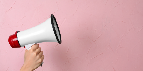 a megaphone against a pink background